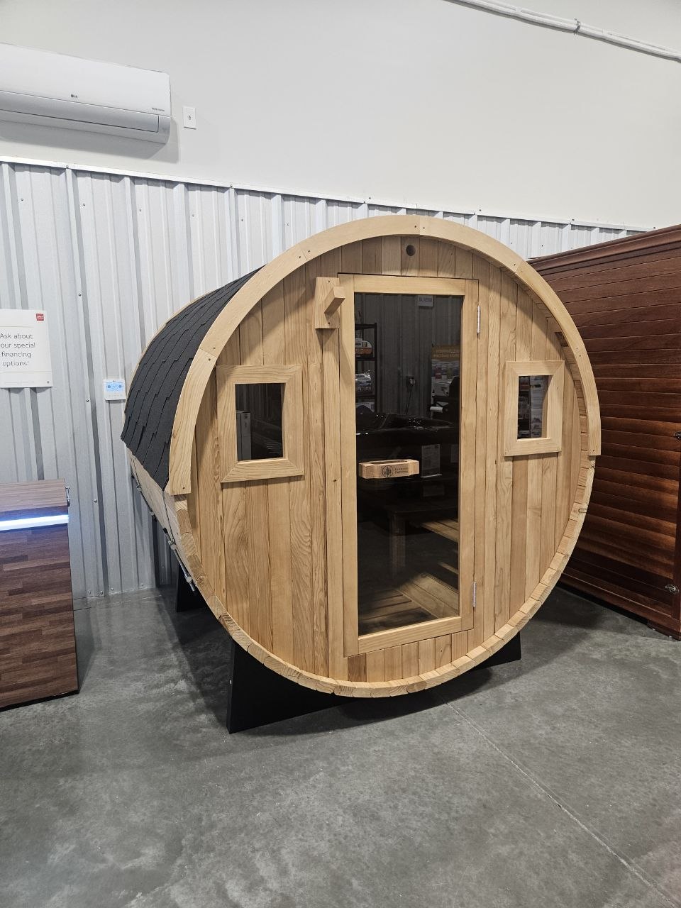 Redwood Outdoors barrel sauna on display at AquaZen showroom in Richland WA — cedar construction with glass door