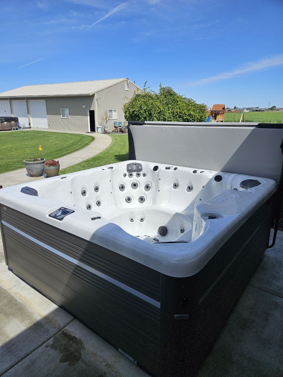 Large Vita Spa hot tub with cover lift delivered to country property in Tri-Cities WA by AquaZen Pool Spa Sauna